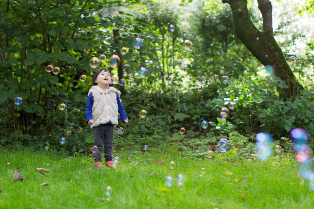 istock baby girl play bubble at Spring garden 1065186140