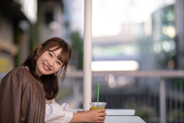 istock Young woman taking a break at open cafe 1065187992