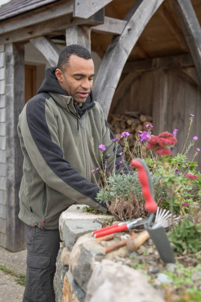 istock Gardener Horticulturalist working on an elevated rock garden 1065188282