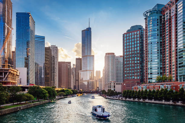 Chicago River Cityscape at Sunset Chicago Cityscape from Chicago River Waterfront at Dusk. Small boats and tourist ferries cruising on the Chicago River towards the Michigan Lake. Chicago, Illinois, USA. promenade stock pictures, royalty-free photos & images