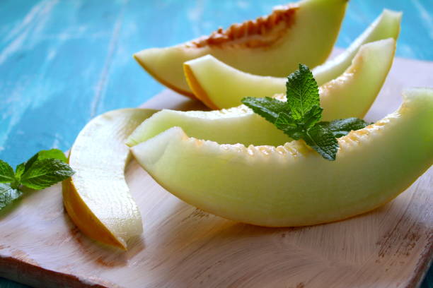 istock Fresh melon slice on the wooden table. 1065196614