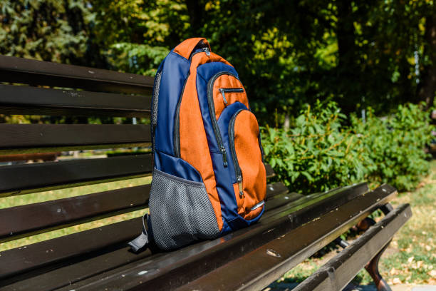 istock Tourist backpack on a bench in city park 1065197022