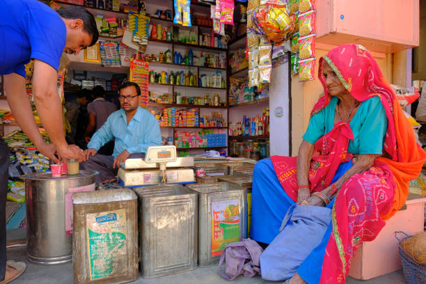 Unidentified seller and buyer in the old street masket in Mandawa, Rajasthan, India. stock photo