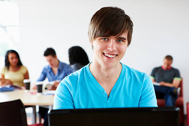 istock handsome male student studying at school with classmates 106520973
