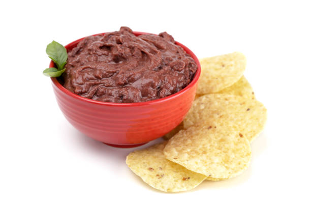 istock A Bowl of Black Bean Dip with Chips on a White Background 1065221212