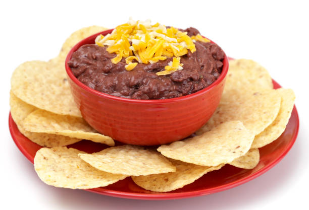 istock A Bowl of Black Bean Dip with Chips on a White Background 1065221674