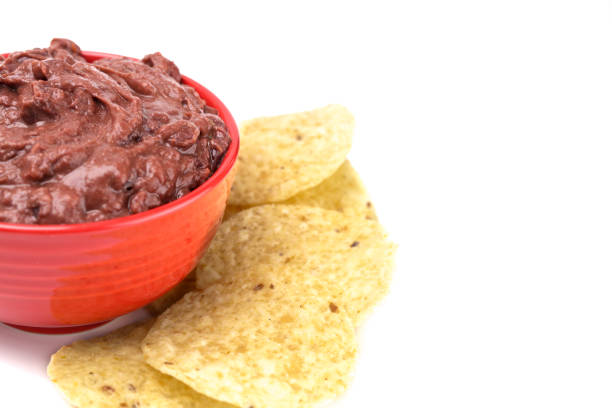 istock A Bowl of Black Bean Dip with Chips on a White Background 1065221676