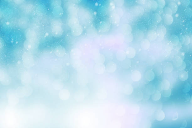 istock Christmas and New year theme background.  Abstract blue blurred or glitter light with snowfall background. 1065234282