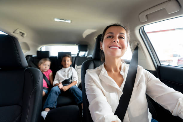istock Happy mother driving a car with her two kids 1065238456