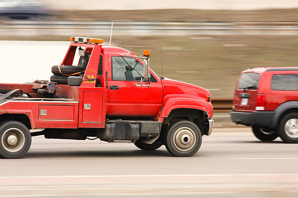 istock Red tow truck speeding on a highway 106524531