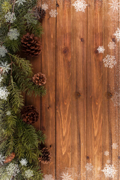 istock Christmas tree branches background, snowflakes all around the frame. 1065248514