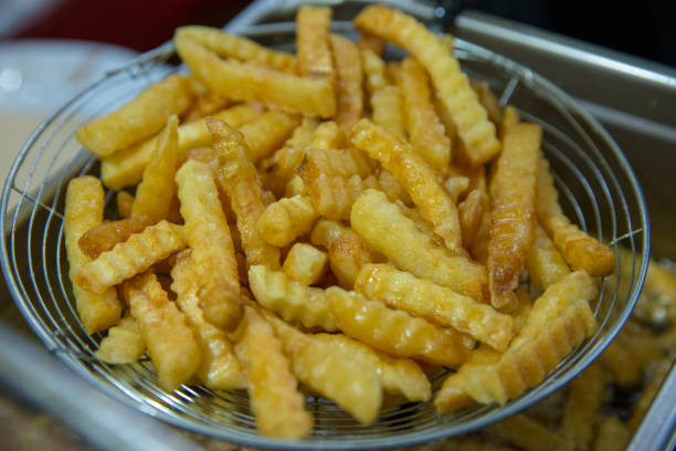 istock Fries potato chips cooking in the fryer stainless 1065252106