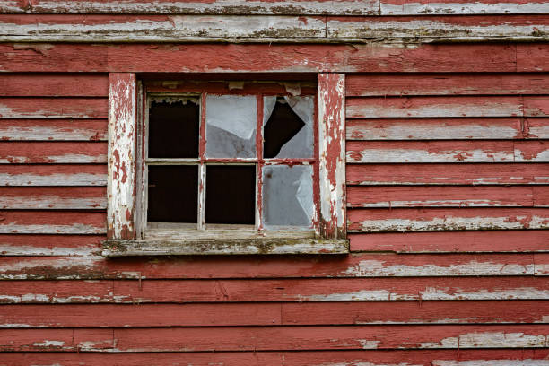 istock Weathered red paint and broken windows are a common site on barns 1065254934