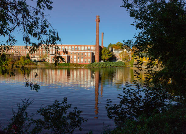 istock A 19th century textile mill has been renovated for modern use, seen reflected in the neighboring river 1065254946