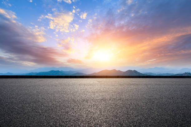 istock Asphalt road and mountains at beautiful sunset 1065255268