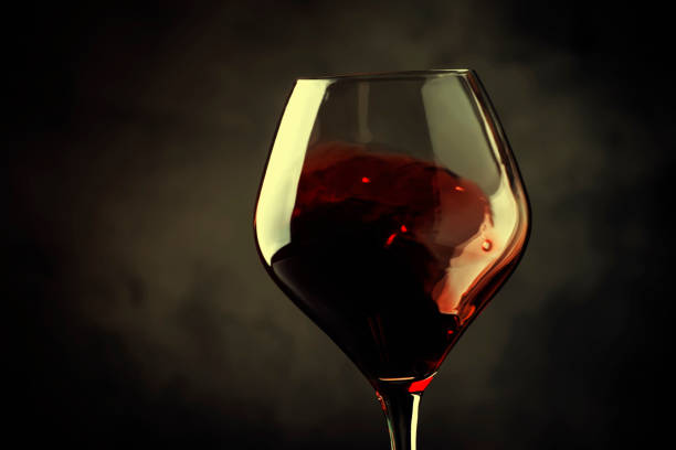 istock Spanish dry red wine, splash in glass, from the tempranillo grape, gray stone background, defocused in motion image 1065256736