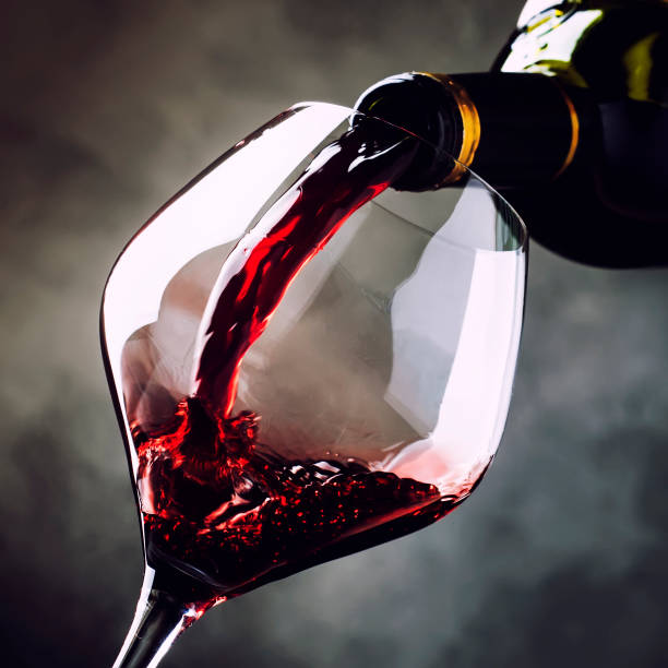 istock French dry red wine, pours into glass 1065257070