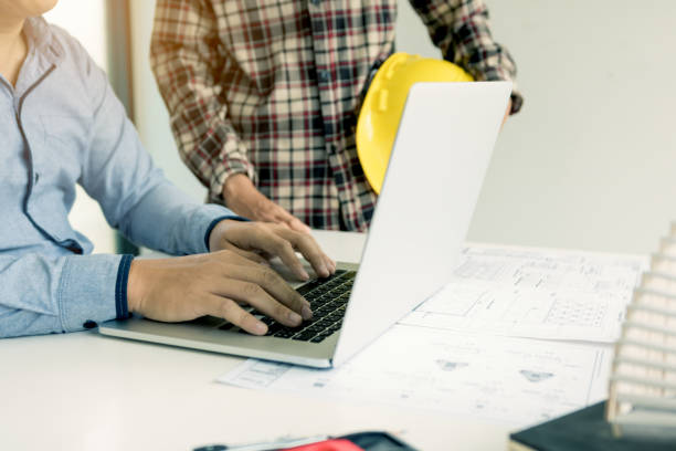istock Engineering discussing new project and using laptop with colleague in office. 1065257166