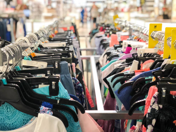 women's clothing of different colors on hangers in department store black friday - textile textile industry warehouse store imagens e fotografias de stock