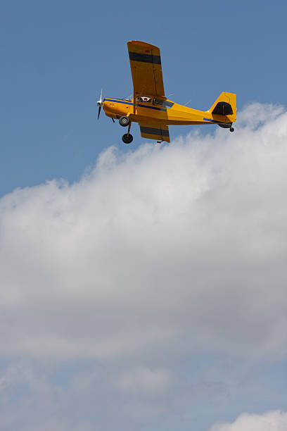 istock Small yellow airplane flying above the clouds 106526466