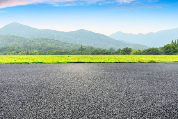 istock Asphalt road and mountains with clouds 1065271122