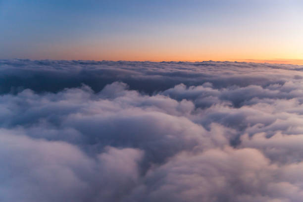 istock Velvet sunset above cloudscape from airplane 1065271312