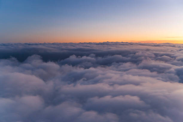 istock Flying above the clouds at sunset. view from the airplane window 1065271416
