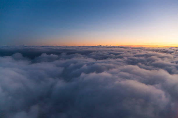 istock Flying above the clouds at sunset. view from the airplane window 1065271536