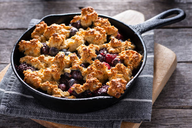 Berry Cobbler Homemade Berry Cobbler in a Cast Iron Skillet cobbler stock pictures, royalty-free photos & images