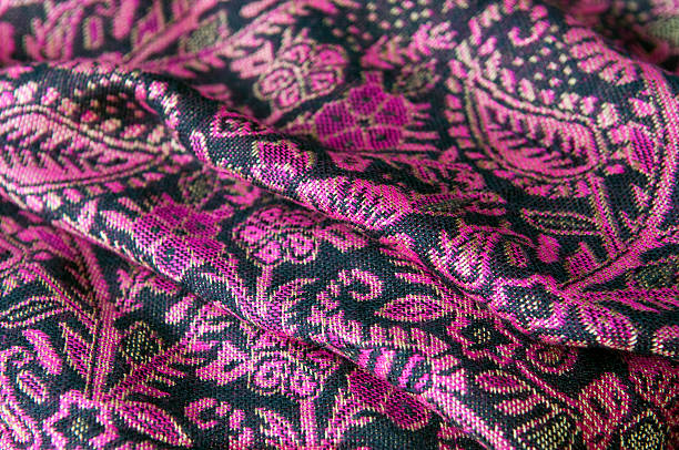 Pashmina and Silk Purple Textile Close-up of soft, beautiful Asian scaff with floral pattern. Shallow dof. pashmina stock pictures, royalty-free photos & images