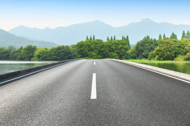 istock Asphalt road and green mountains 1065274598