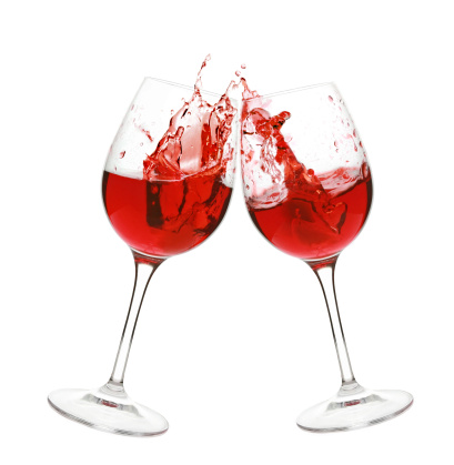 Red wine splash in two glasses, isolated on a white background