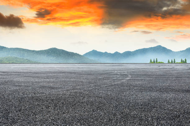 istock Asphalt road pavement and mountain at beautiful sunset 1065276618