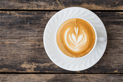 coffee cup latte art On a wooden background. top view