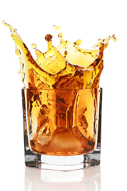 istock Glass with splashing whisky drink 106527701