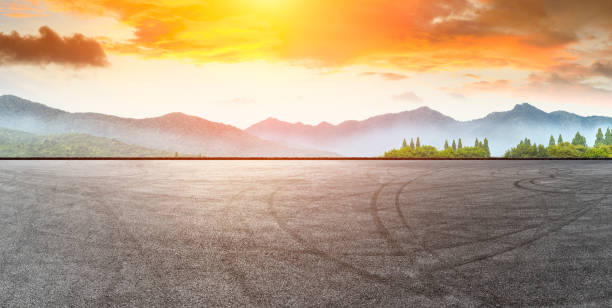 istock Asphalt road pavement and mountain at beautiful sunset 1065277870