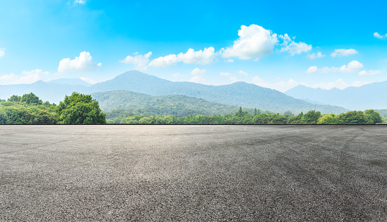 Empty asphalt road pavement and green mountain