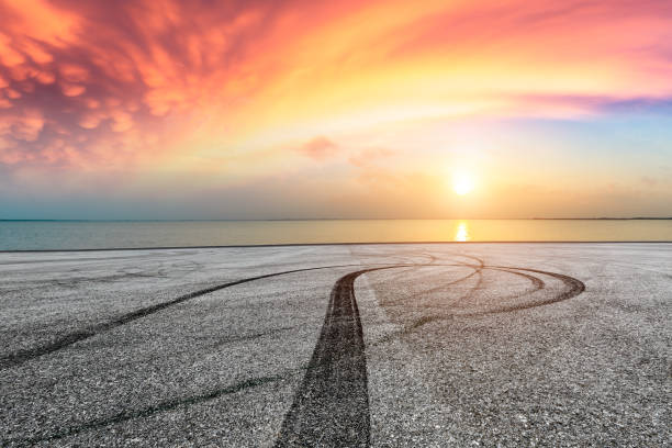 istock Asphalt road pavement and dramatic sky with coastline 1065278878