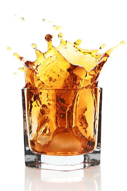 istock Glass with splashing whisky drink 106528014