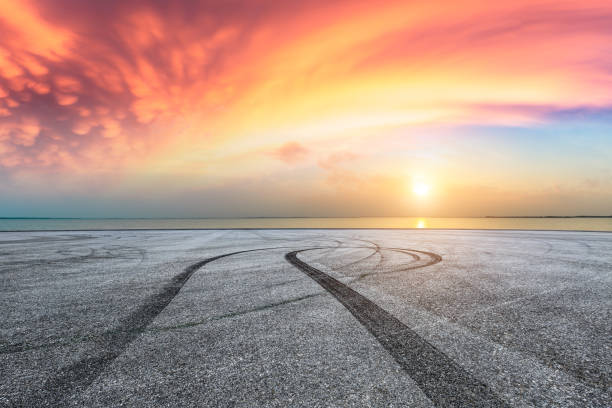 istock Asphalt road pavement and dramatic sky with coastline 1065280228