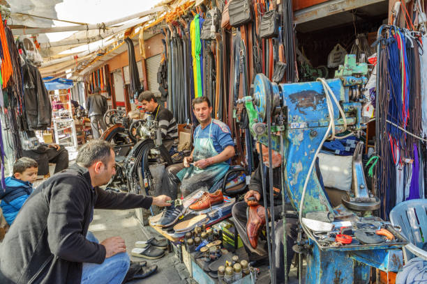 Many local cobblers and their customers are in an alley of Sur district of Diyarbakır, Turkey. Diyarbakır is one of the largest cities in southeastern Turkey with a population of about 930,000.