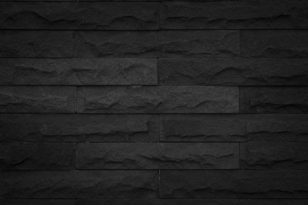 istock Seamless Black pattern of decorative brick sandstone wall surface with concrete of modern style design decorative uneven have cracked realmasonry wall of multicolored stones or blocks with cement. 1065280938