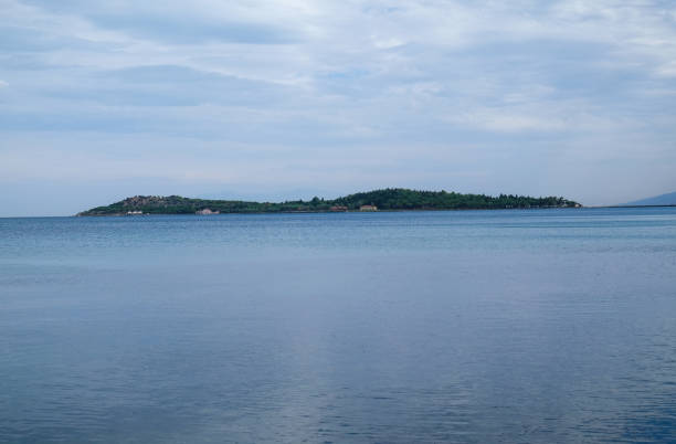istock island, sea and cloudy sky 1065280944