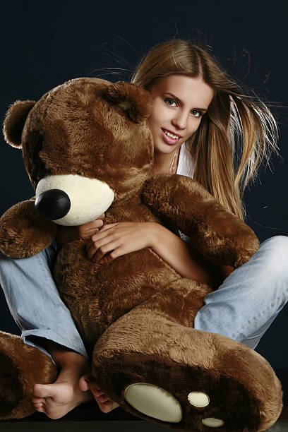 istock Young pretty woman with big teddy bear 106528790