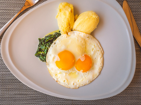 Cute Breakfast for children, fried eggs, mashed potatoes and spinach. Food decoration as cute rabbit.