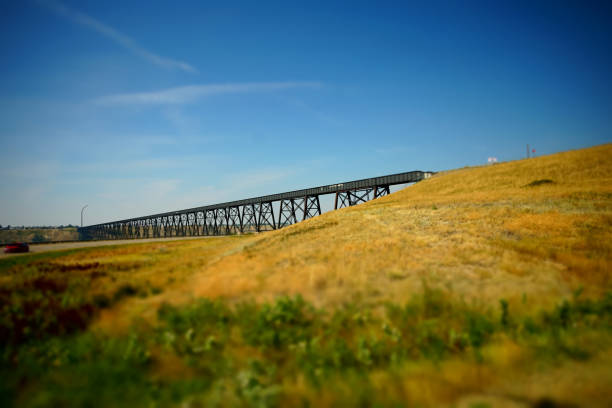Old railway bridge over river used for transportation and cargo Old railway bridge over river used for transportation lethbridge alberta stock pictures, royalty-free photos & images