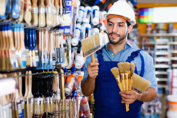 istock Handyman preparing for renovation works choosing brushes in paint store 1065302228