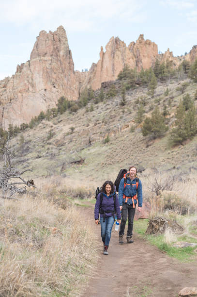 istock Two friends backpack along a dry wilderness trail together 1065303846