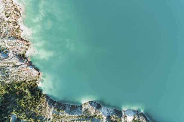 an old gypsum quarry filled with blue and pure water. aerial view, from top to bottom - coastline aerial view forest pond imagens e fotografias de stock