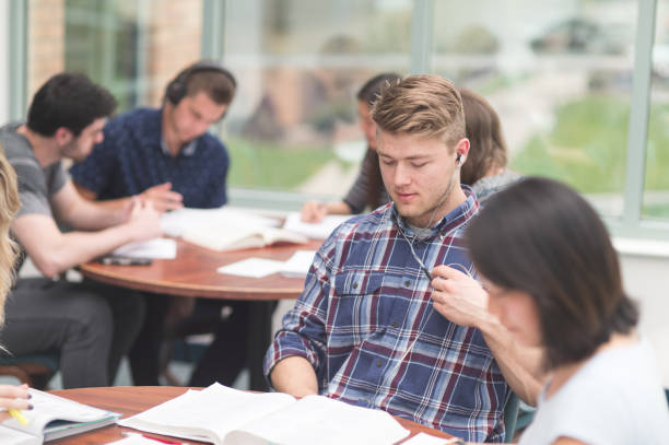istock College students working on an assignment together in the library 1065307602